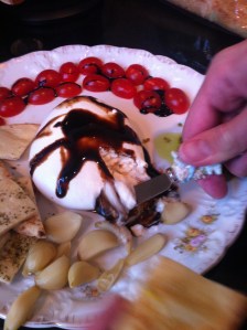 Burrata di buffalo with roasted garlic, Italian naan, balsamic glaze, grape tomatoes and home made pesto.